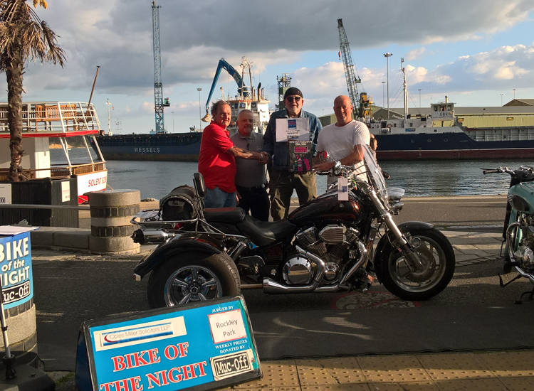 Winner of Bike of the Night pictured on Poole Quay with Judge and motorbike.